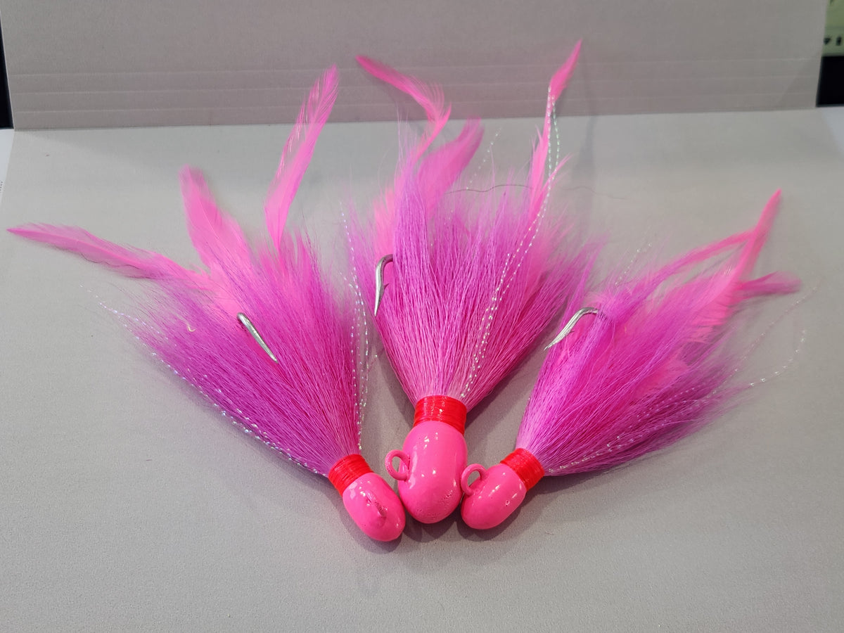 Pink bucktail jig custom with feathers and flash.
